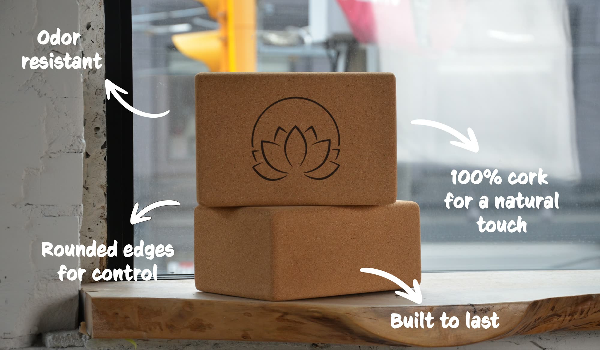 Two stacked cork yoga blocks labelled: odor resistant, 100% cork for a natural touch, rounded edges for control, built to last.