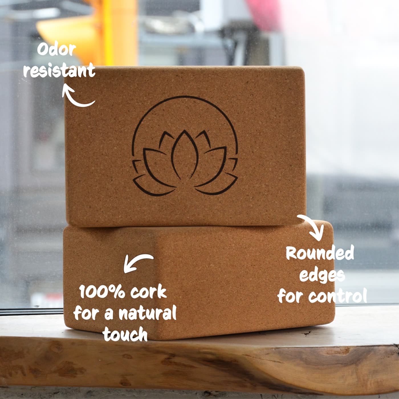 Two stacked cork yoga blocks labelled: odor resistant, 100% cork for a natural touch, rounded edges for control.